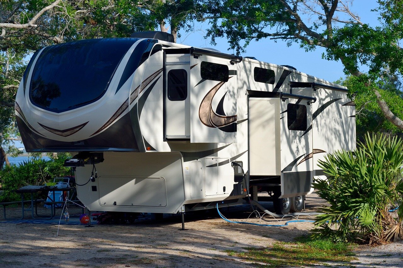 Camper trailer with awning in the mountains
