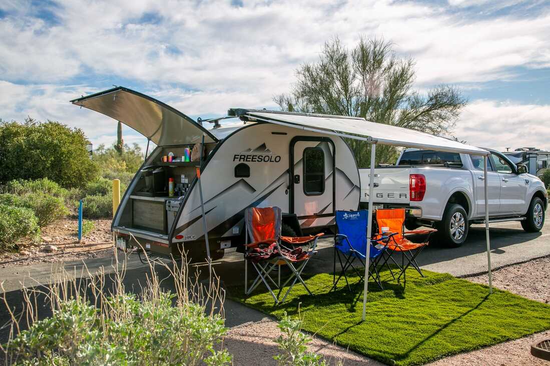 Modern motorhome parked at a sunny campsite